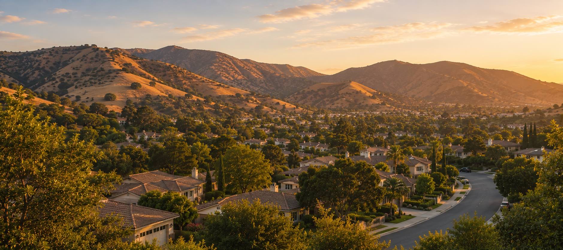 Agoura Hills in late-afternoon light — oak-dotted Conejo Valley ridges above quiet residential rooftops